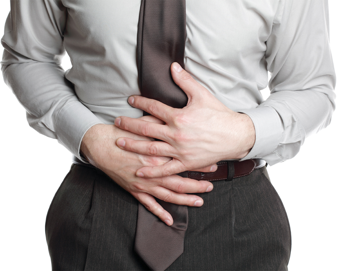 Businessman holding his stomach in pain or indigestion