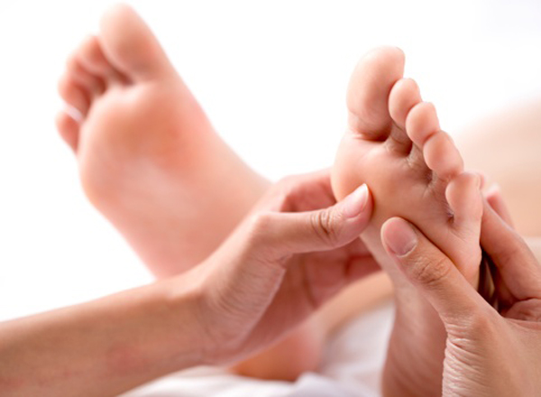 Young woman having feet massage (focus on feet)