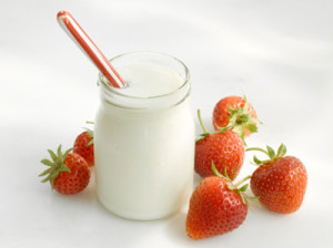 Jar of yoghurt and fresh strawberries